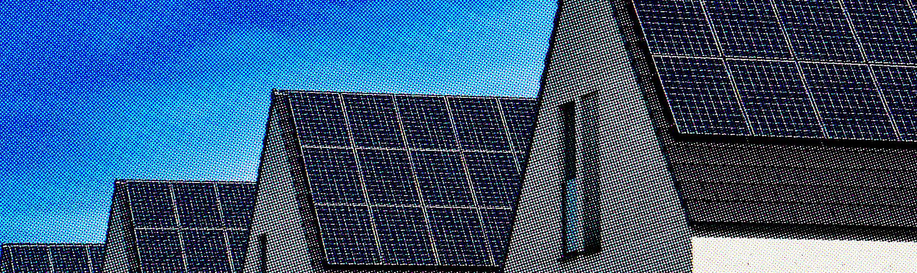 Rooftop solar panels installed across residential homes against a bright sky.